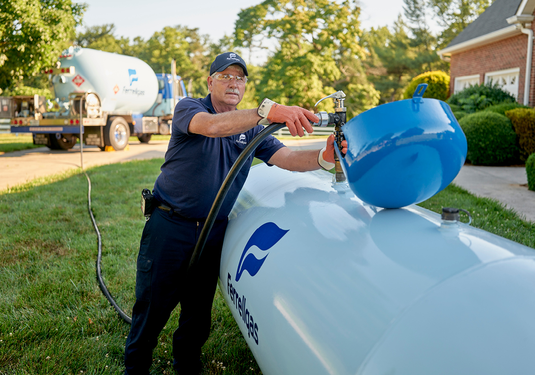 Ferrellgas Delivery Driver filling a residential propane tank.