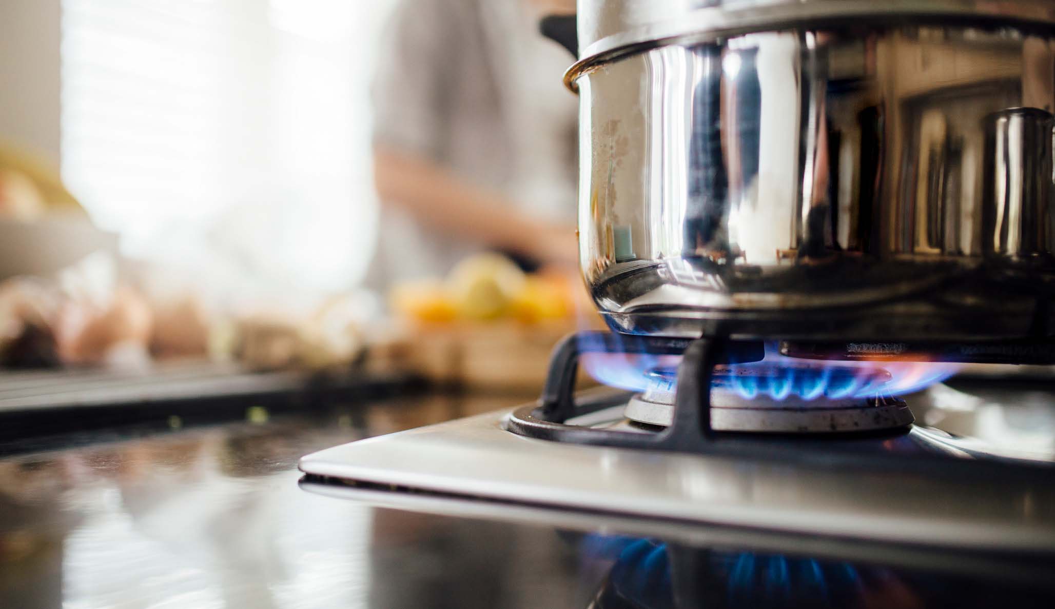 Gas stove at home, natural propane gas burns in kitchen, blue fire